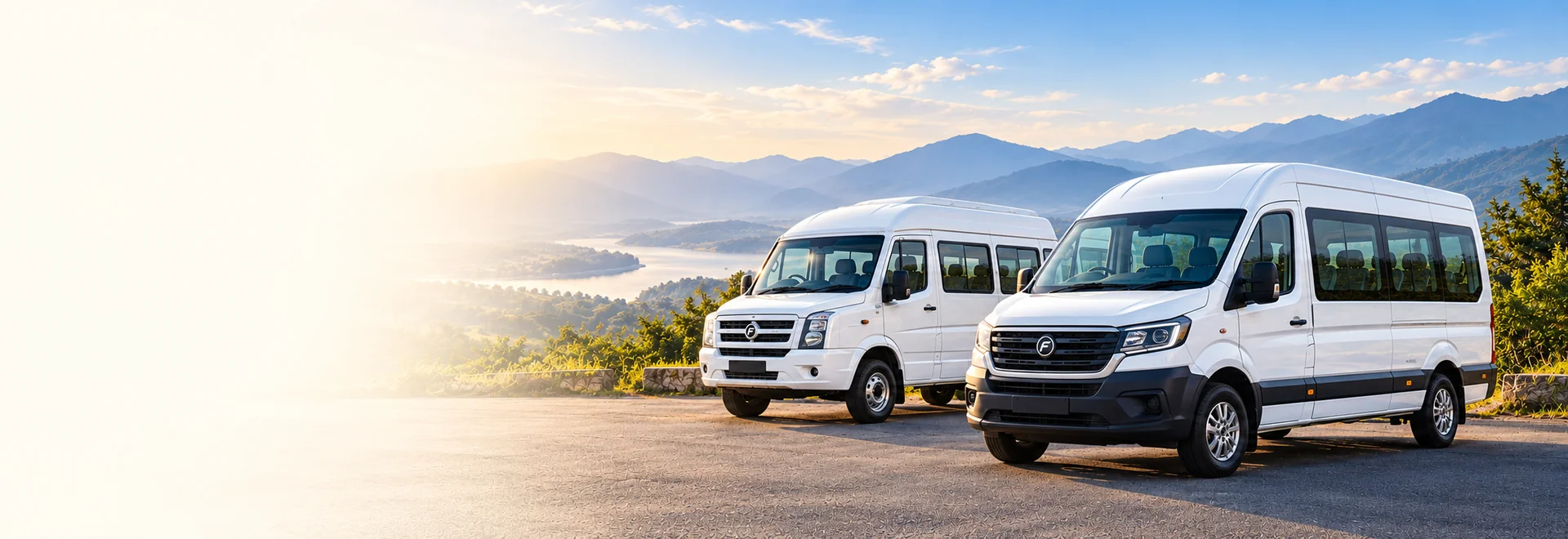 White Tempo Traveller and Urbania beside a scenic road